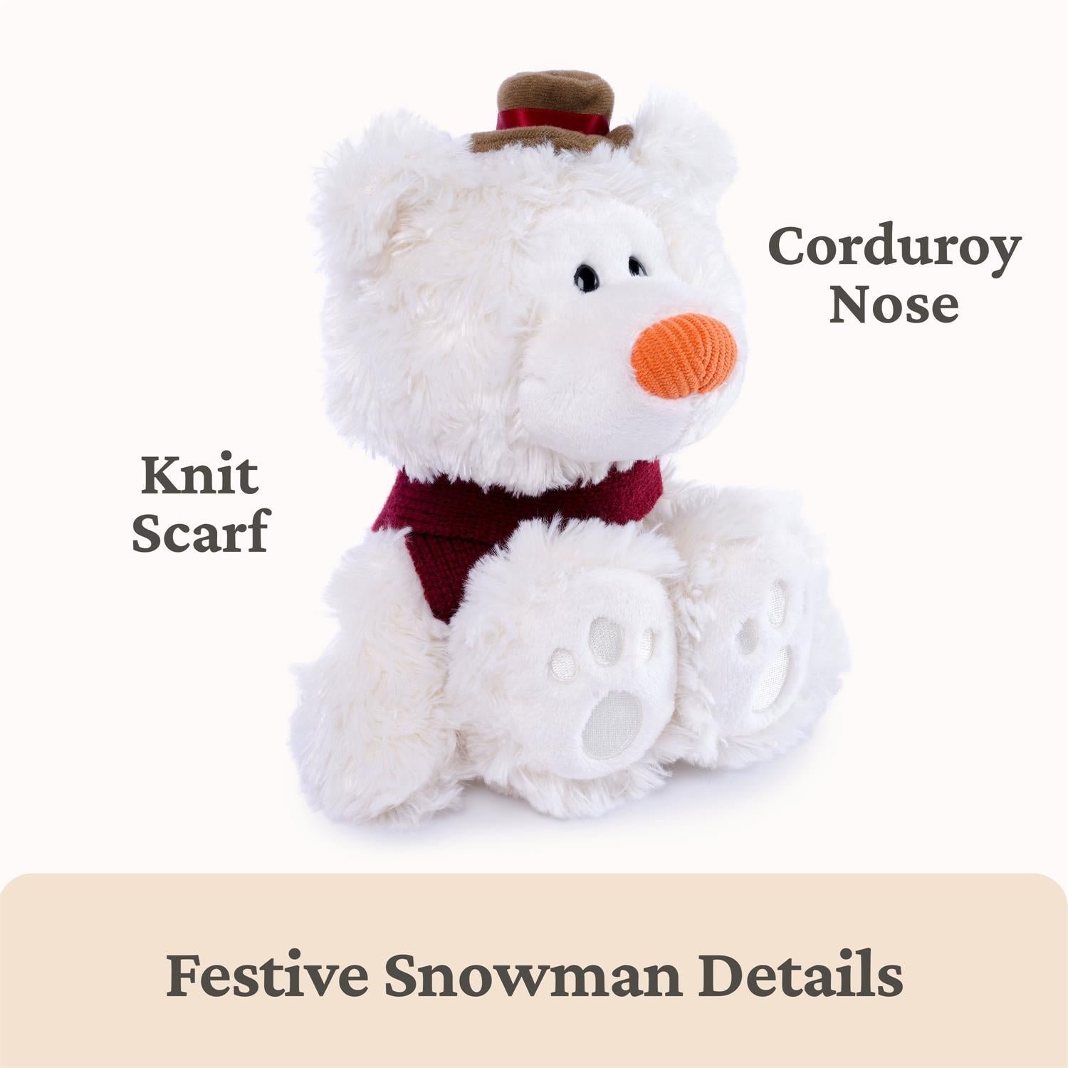 A white plush teddy bear styled as a festive snowman, wearing a dark red knit scarf and a small brown hat with a red band. The image includes text callouts reading 'Corduroy Nose', 'Knit Scarf', and 'Festive Snowman Details' on a light background.