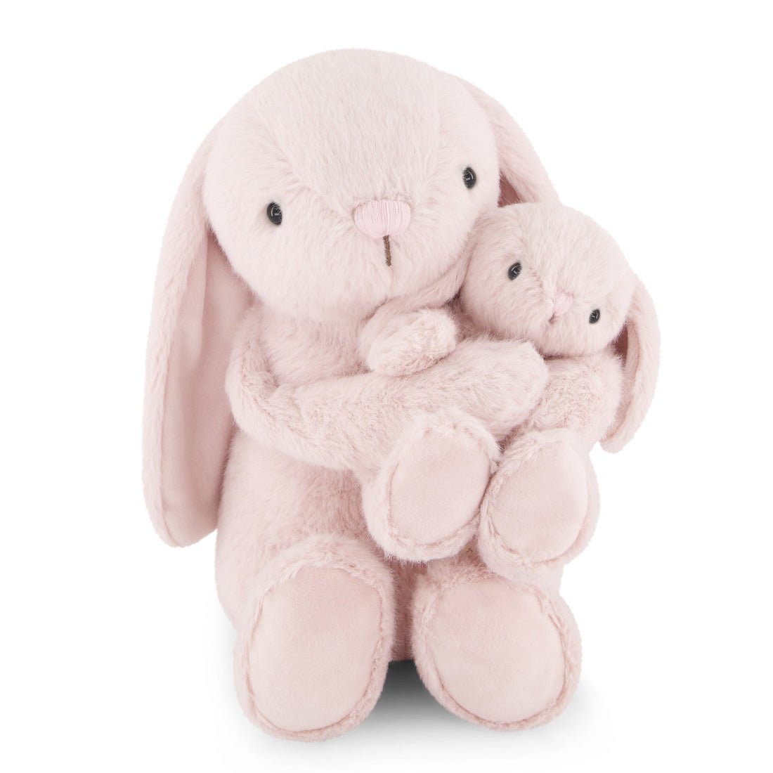 Two pink stuffed bunnies hugging.